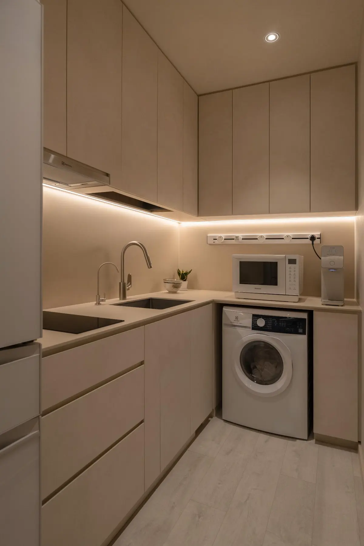 Kitchen — matte cabinetry with underlighting, integrated appliances