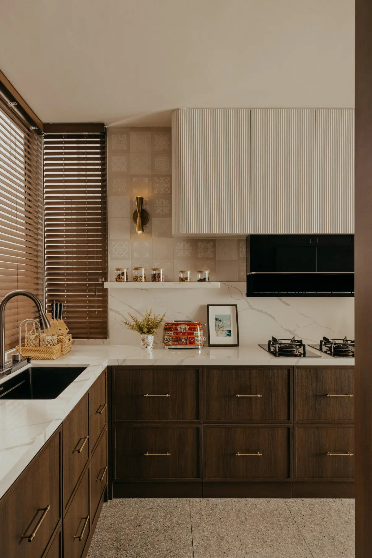 Aiden T — kitchen with deep wood cabinetry and fluted range hood