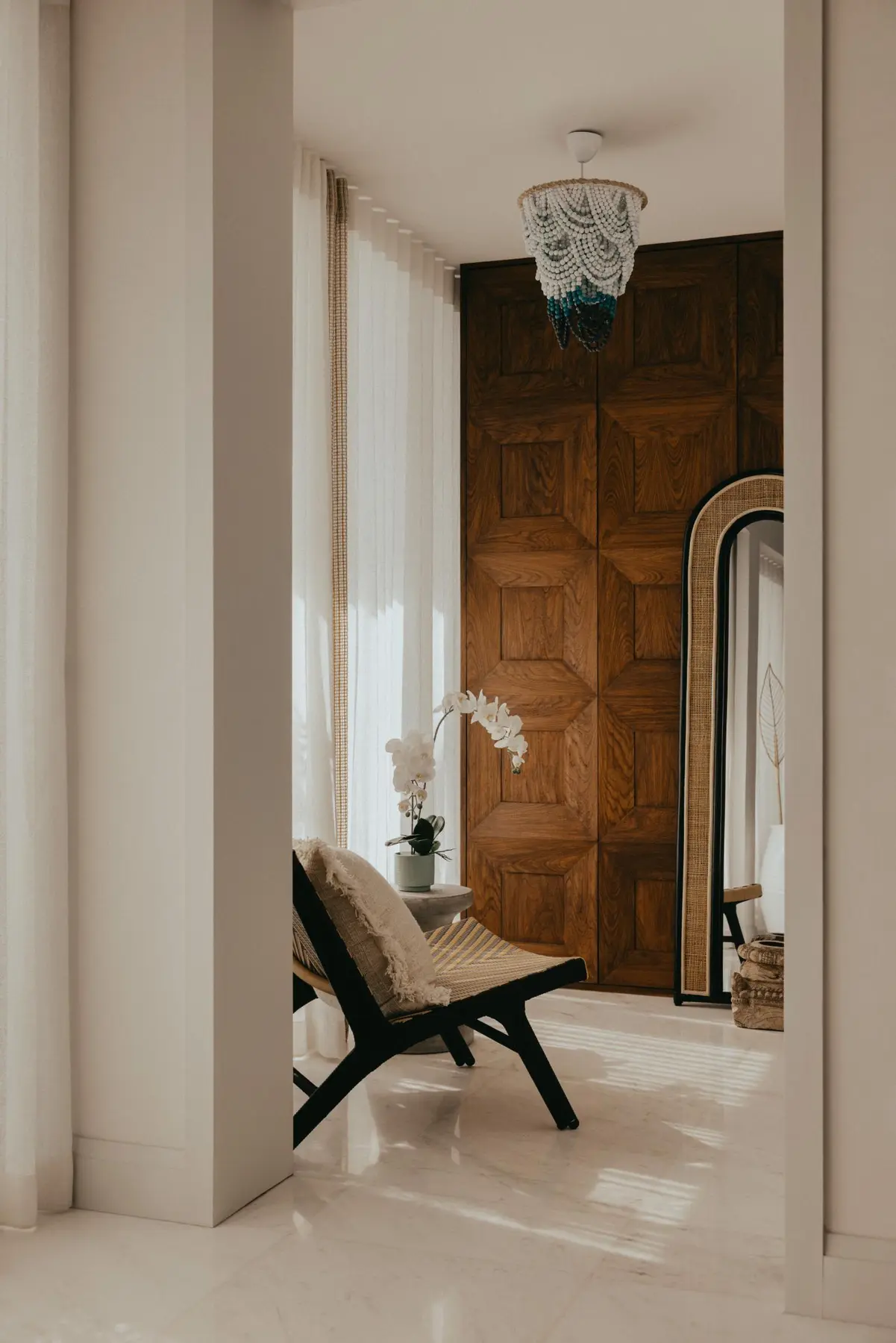 Aiden T — primary bedroom floating toward the sea with cork and gold leaf wardrobe doors